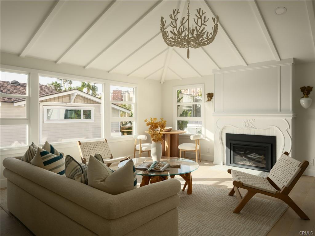 2715 Cove Street — upper living room with vaulted beamed ceiling and fireplace