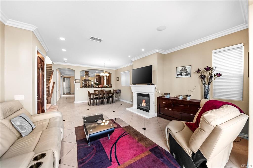 116 11th St — Living room with fireplace, mounted television, and ocean-side windows