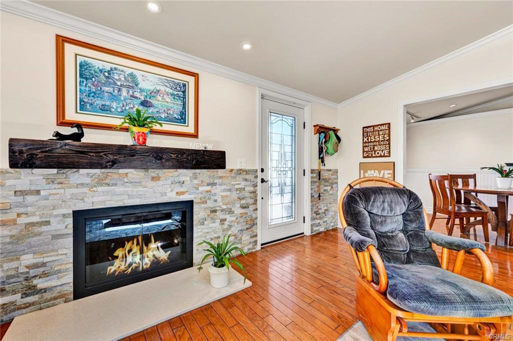 12231 Wilken Way — living room fireplace with stone surround and wood mantel