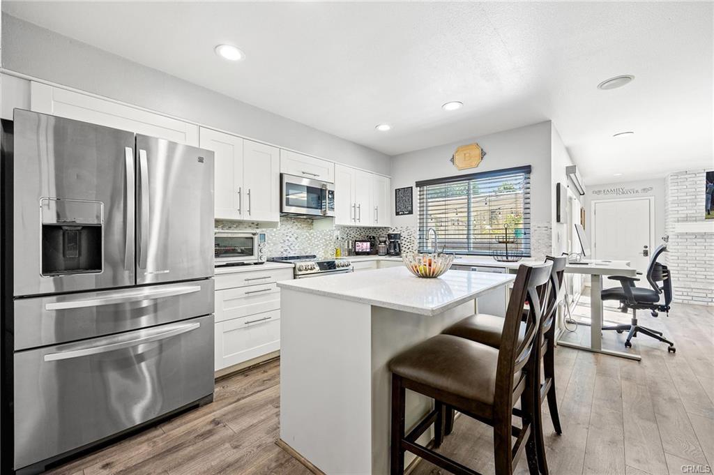 18126 Sand Dunes Ct — renovated kitchen with center island, quartz counters, and stainless Cafe appliances