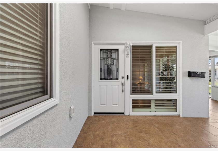 1200 Canoe Brook Dr #19D — custom leaded glass front door at the entry of the patio home