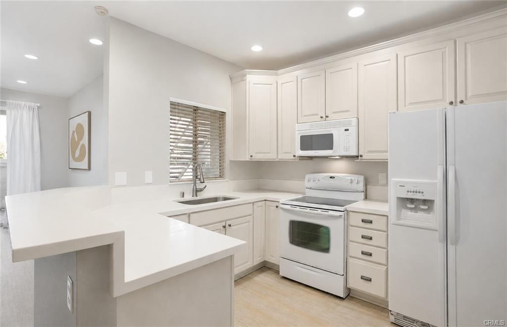 16440 Atherton St #26 — kitchen with quartz counters and breakfast bar