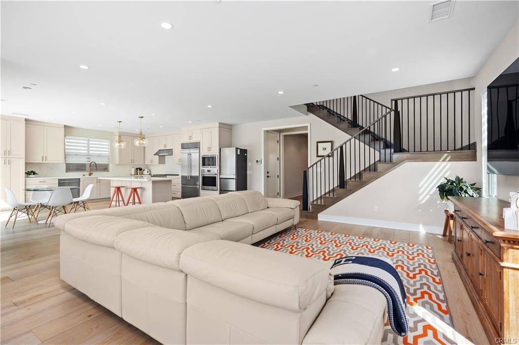 142 Sabbia — open living and dining space with iron staircase