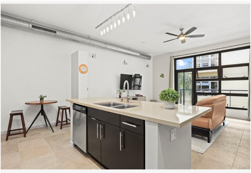 133 The Promenade N #318 — kitchen island with bar seating open to the living space