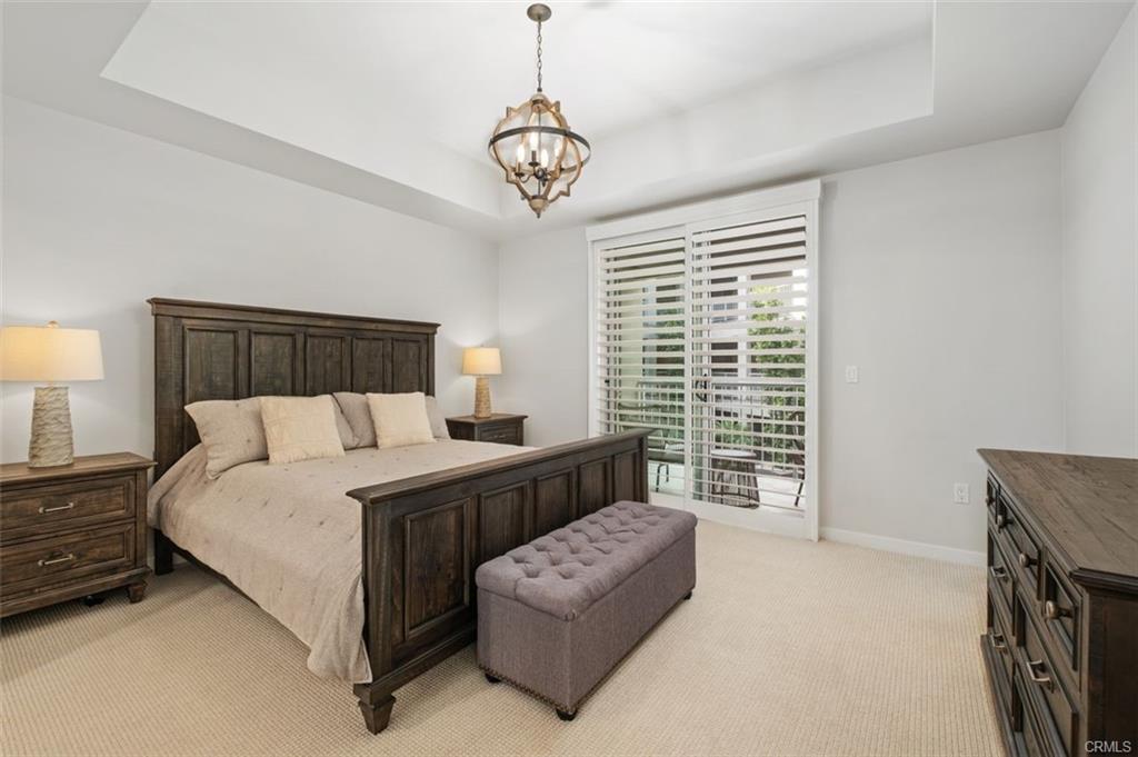 21 Gramercy #202 — primary bedroom with plantation shutters