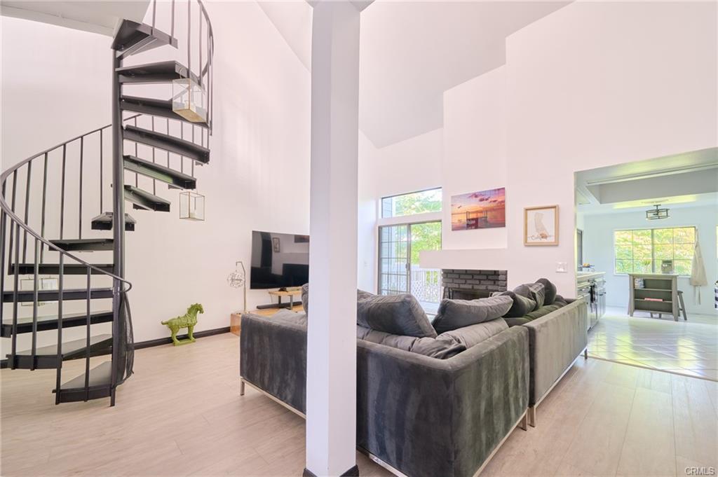 8132 Atwater Cir #202 — spiral staircase and light-filled main living space