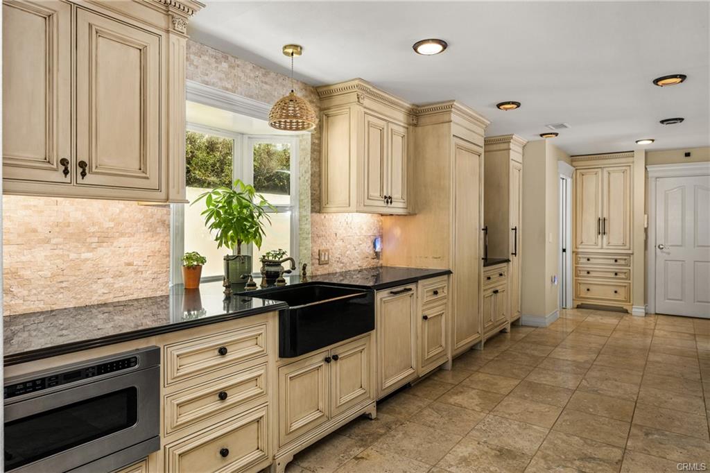 2342 Cynthia Ct — kitchen with farmhouse sink, stone counters, and custom cabinetry