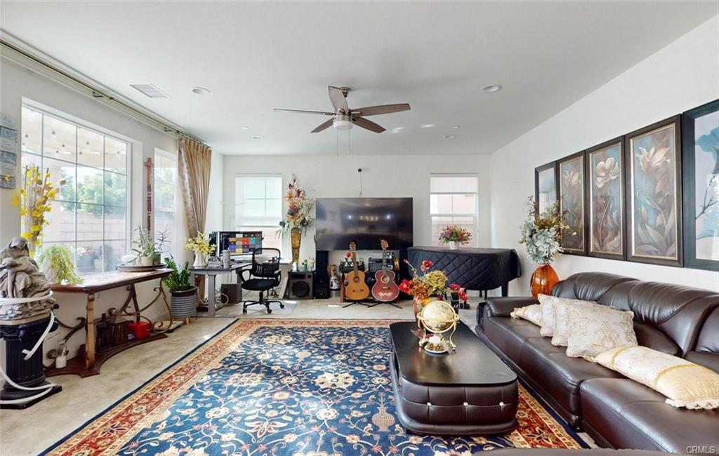 12954 Dahlia St — open-concept great room with tile flooring and abundant natural light