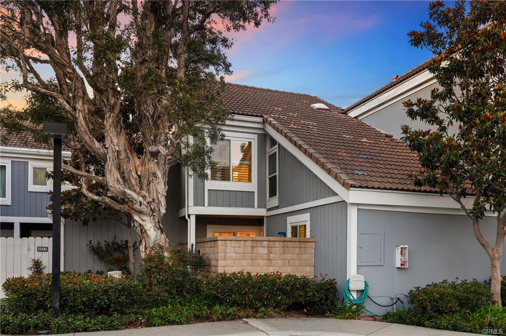 3631 Windspun Dr — front exterior and detached two-car garage at dusk