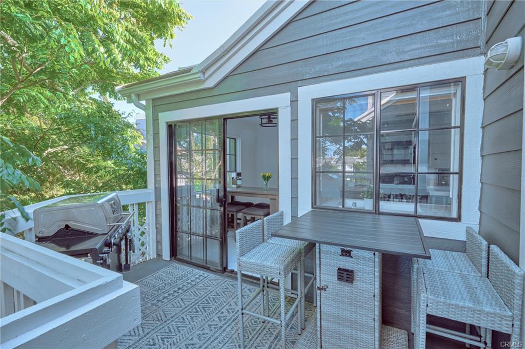 8132 Atwater Cir #202 — balcony seating overlooking the trees and stream