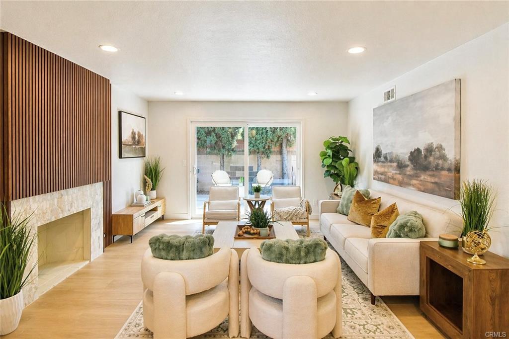 9142 Parliament Ave — family room with fireplace and sliding doors to the backyard