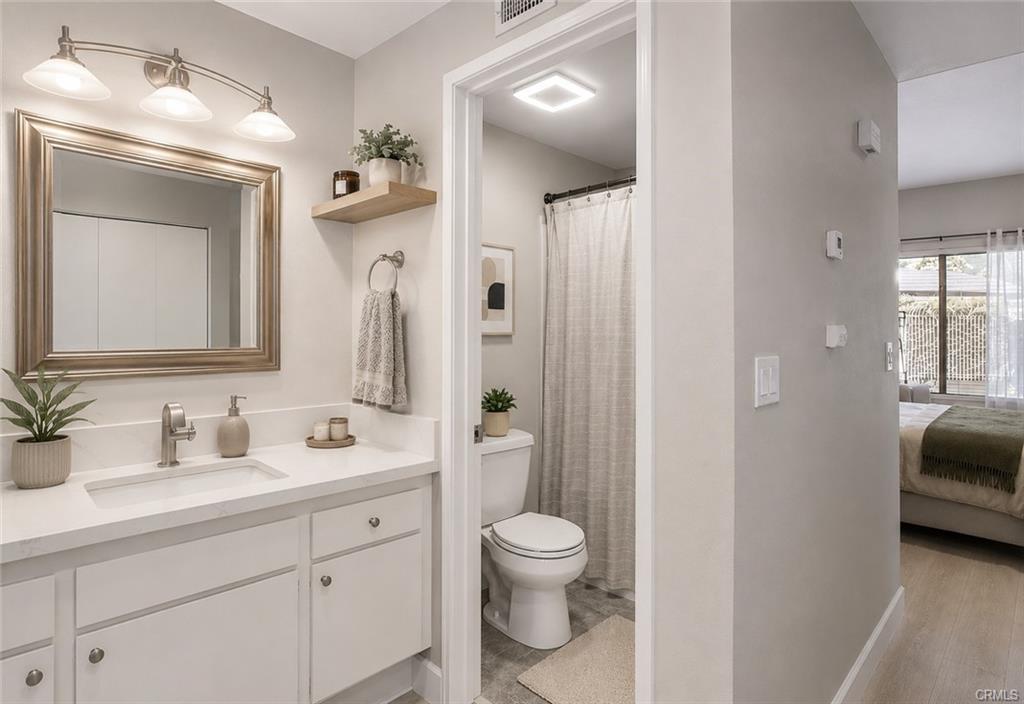 16440 Atherton St #26 — full bathroom with vanity and framed mirror