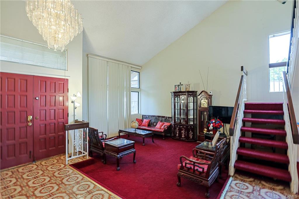 17031 Ward St — living room with vaulted ceiling and French double door entry