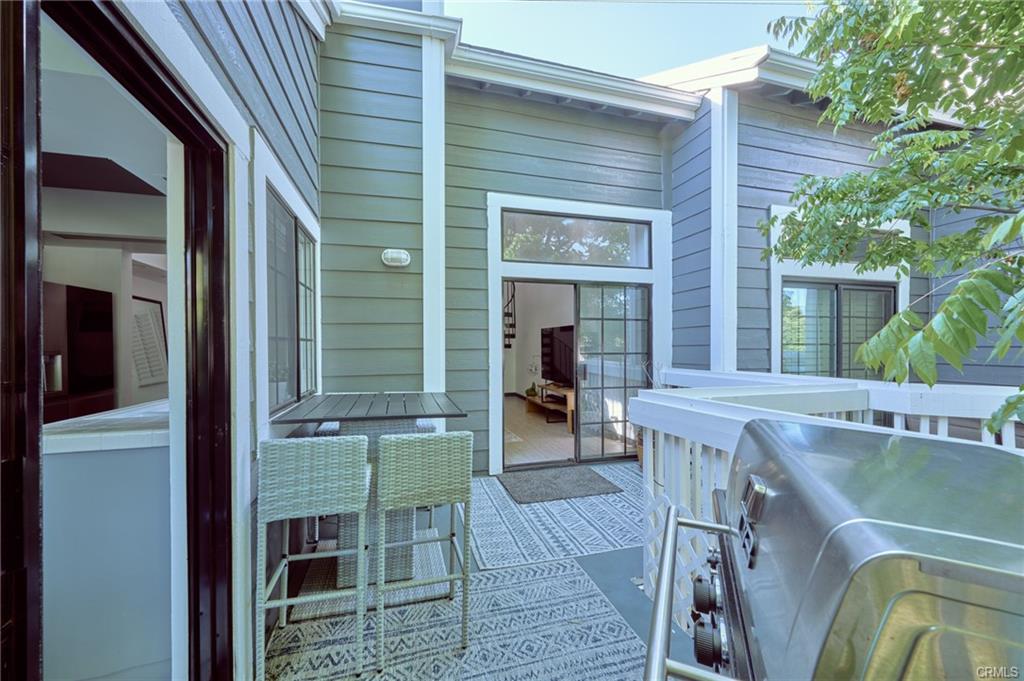 8132 Atwater Cir #202 — private balcony with outdoor grill and dining area