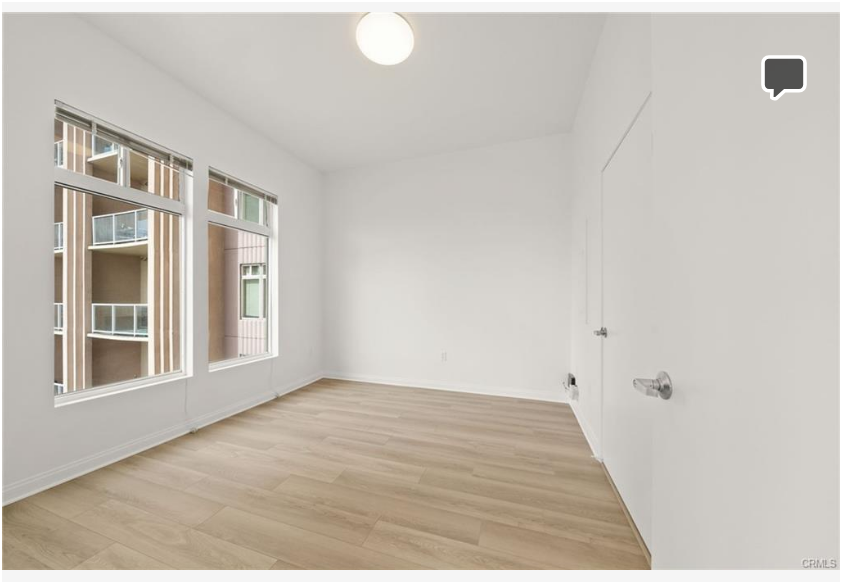 488 E Ocean Blvd #717 — bedroom with large windows and coastal light