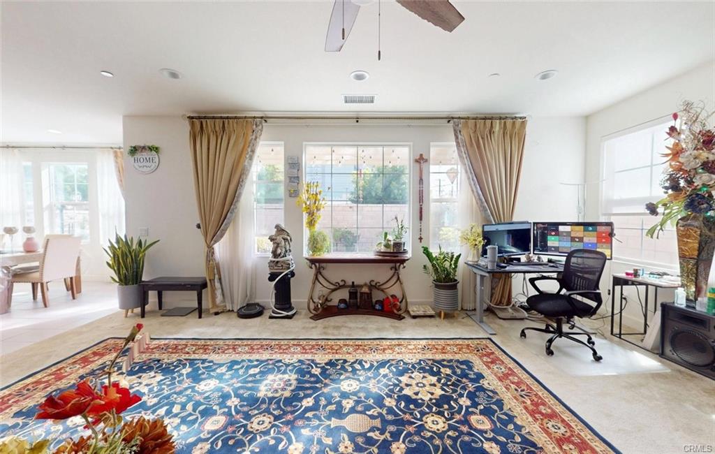 12954 Dahlia St — living area opening to the kitchen and casual dining space