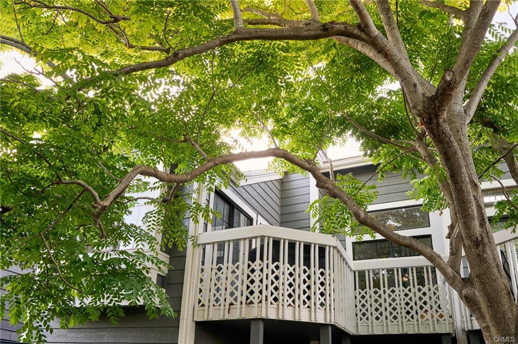 8132 Atwater Cir #202 — upper-level deck shaded by mature trees