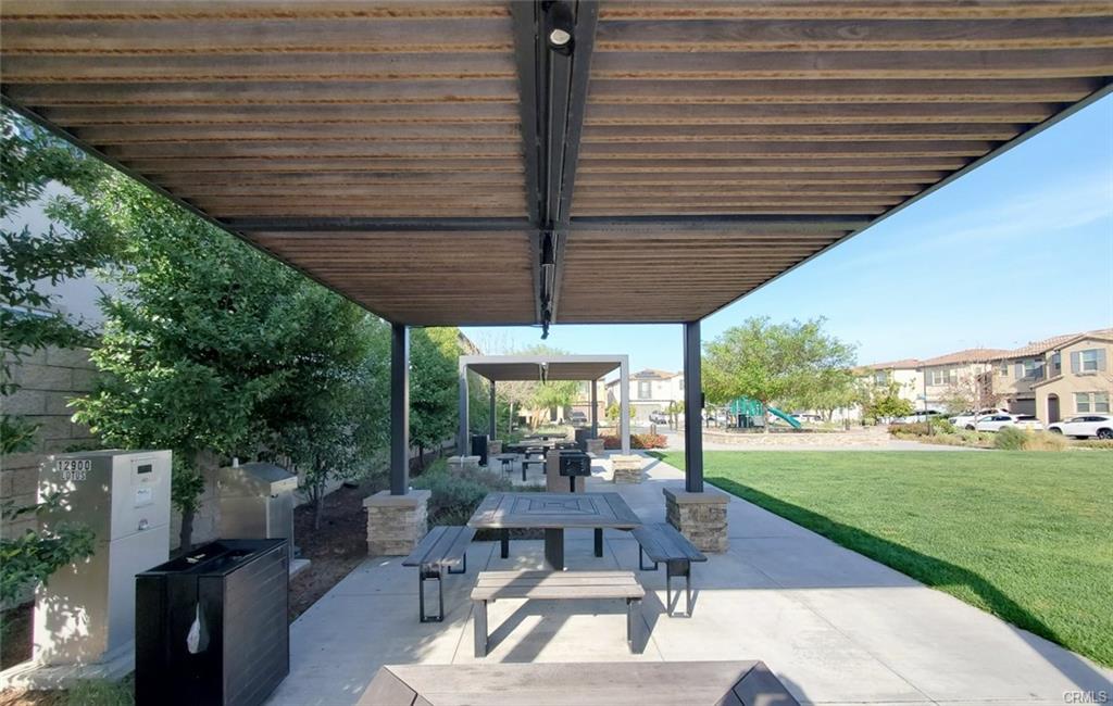 12954 Dahlia St — covered patio overlooking the community lawn