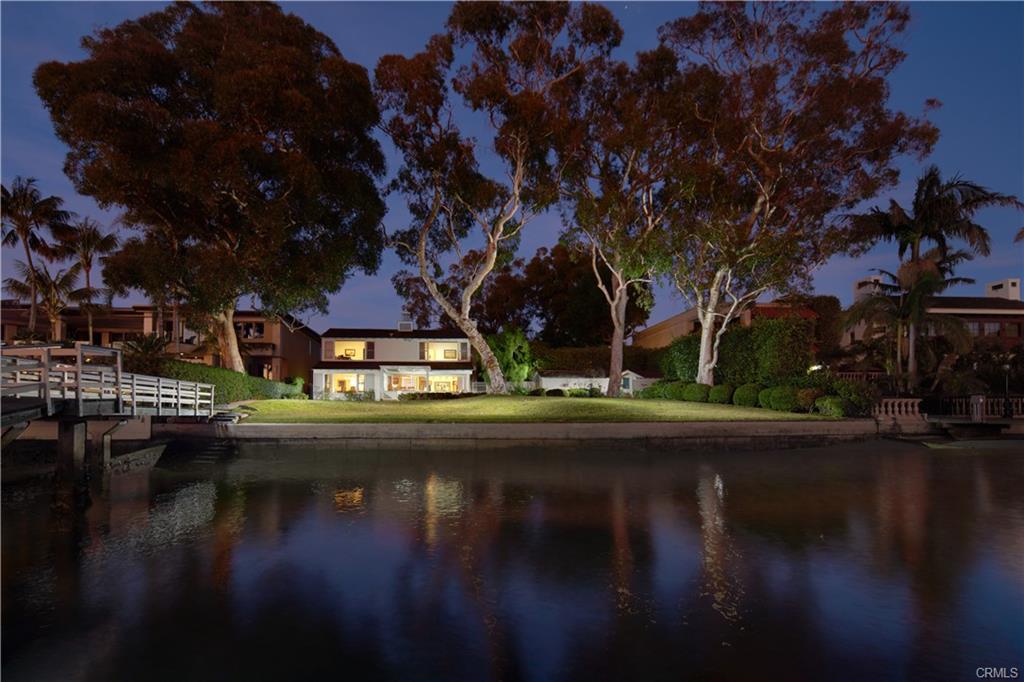 20 Harbor Island — bayfront elevation of the residence at dusk
