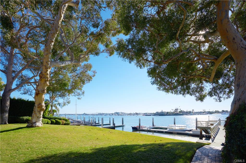 20 Harbor Island — lawn framed by specimen trees overlooking the bay