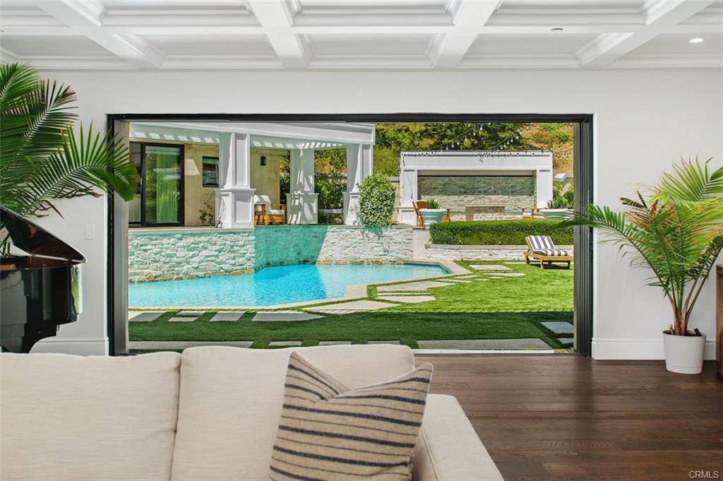 4 Inverness Lane — great room opening through glass walls to the pool