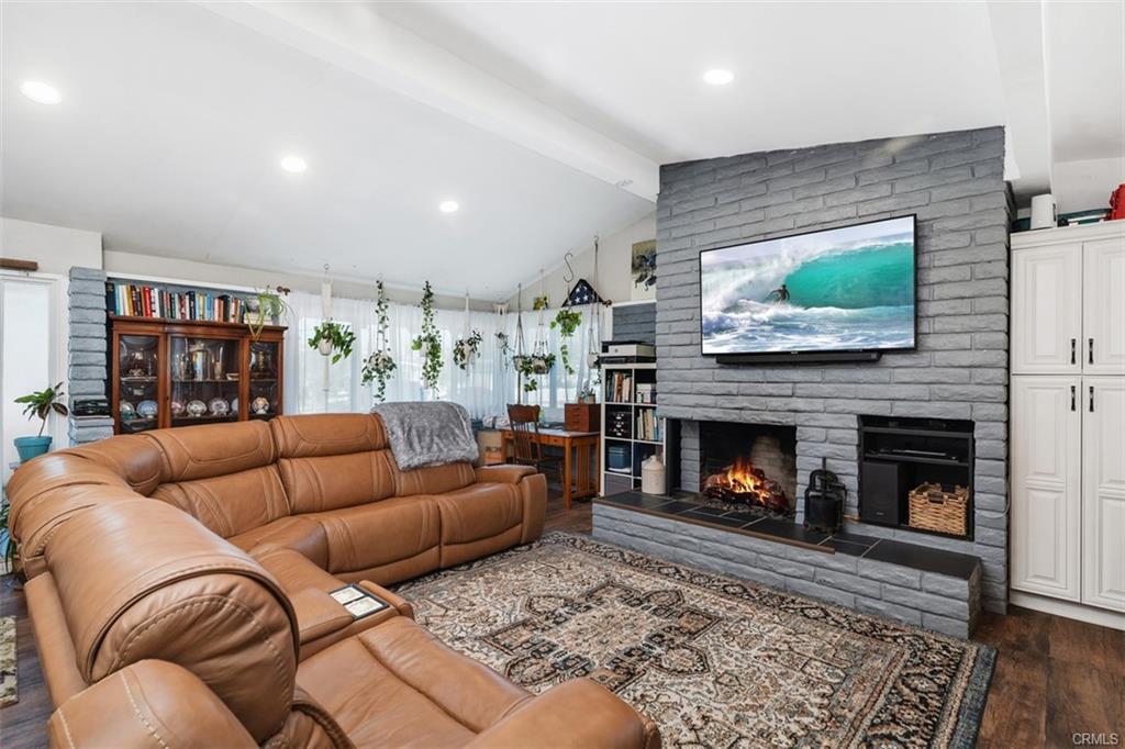 20292 Riverside Dr — living area with stone fireplace and built-ins