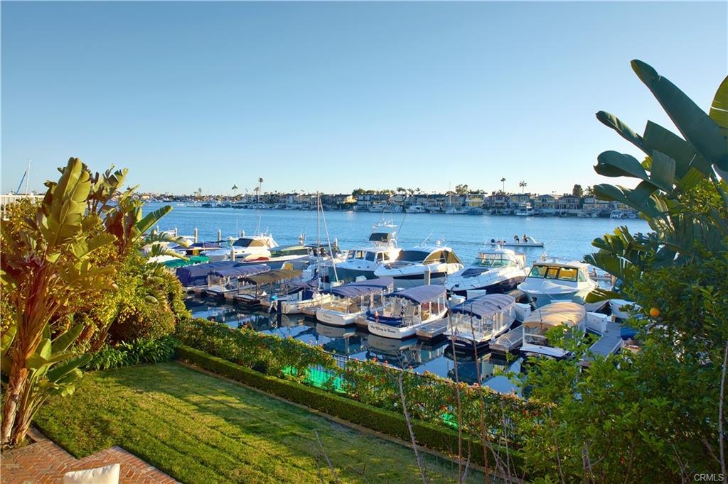 2572 Bayshore Dr — lawn and brick patio at the water's edge